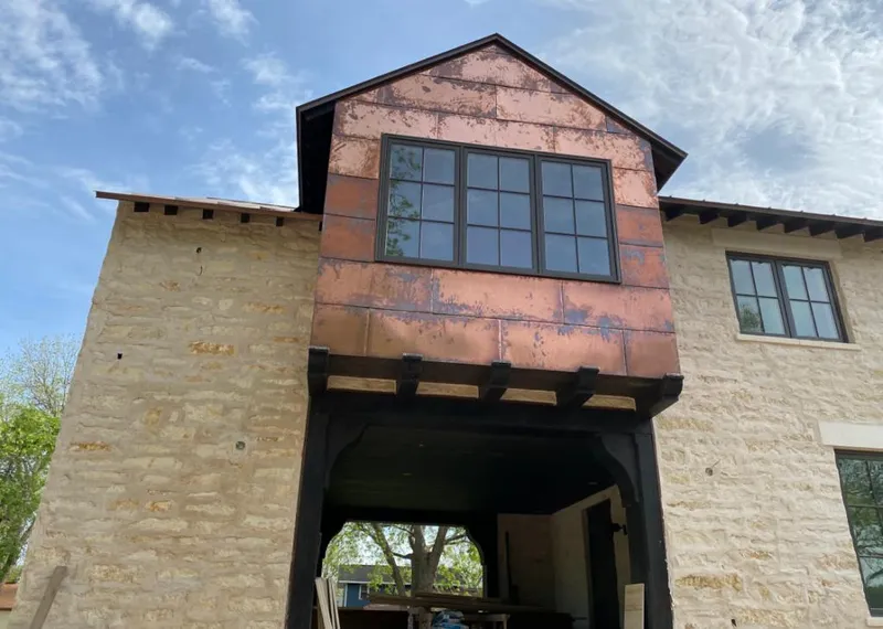 Copper metal panel facade on a stone building for Roof Repair in Hollister